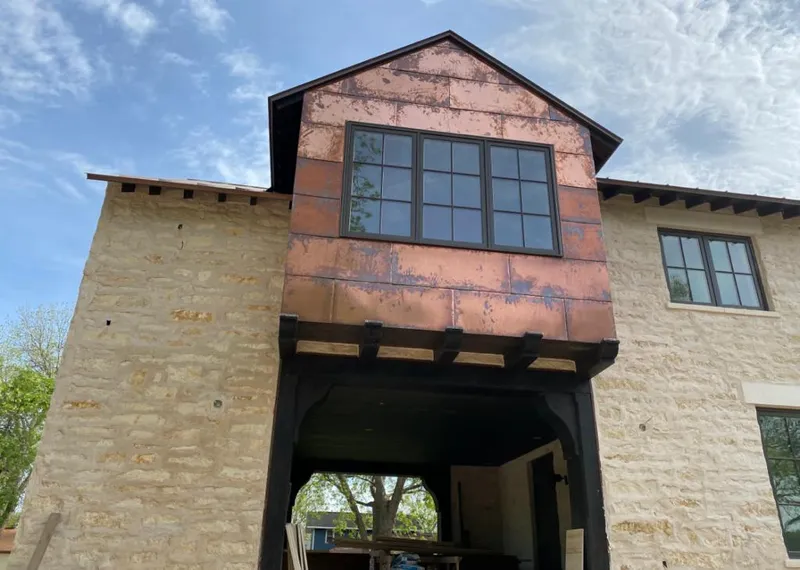 Copper metal panel facade on a stone building for Skylight Installation in Putnam
